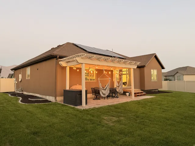 Expansive green lawn with a privacy fence