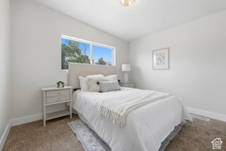 Carpeted flooring, neutral wall tones, recessed window, and flush mount lighting