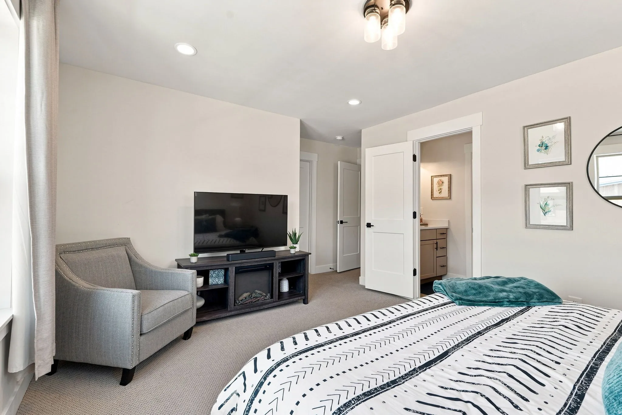 Recessed lighting, flush mount ceiling fixture, carpeting, and white trim throughout