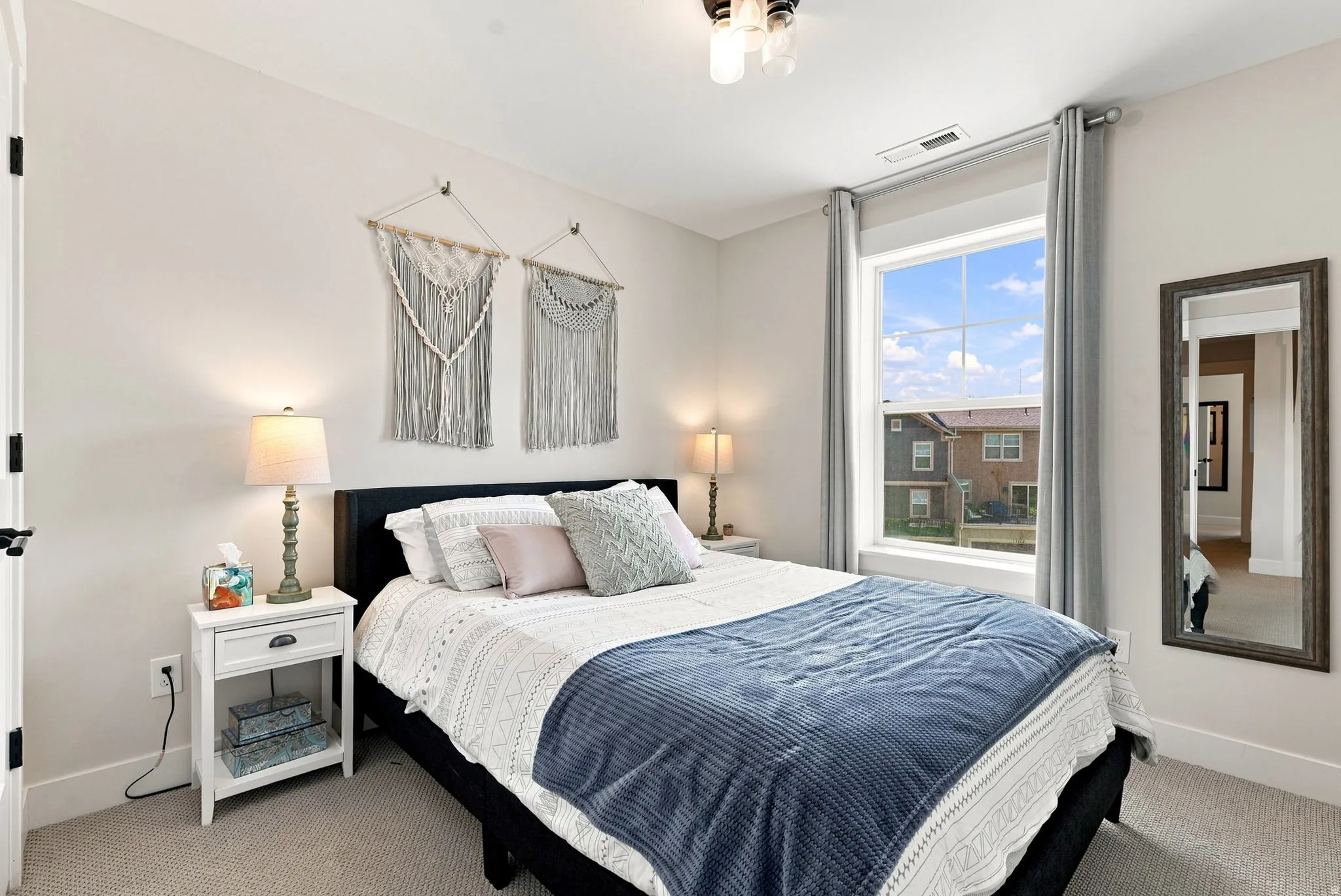 Recessed lighting and a large window with vertical blinds