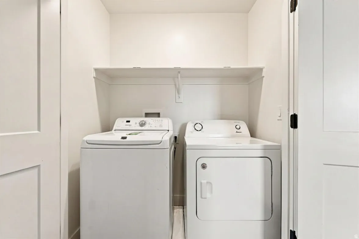 Dedicated laundry area featuring a white washing machine and a white dryer