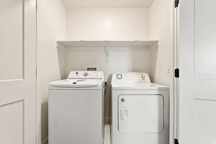 Dedicated laundry area featuring a white washing machine and a white dryer