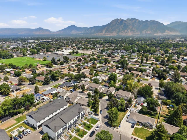 Townhome community with mountain scenery, mature trees, and nearby green spaces
