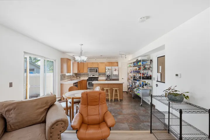 Kitchen featuring wood-finish cabinetry, stainless steel appliances, and an eat-at island