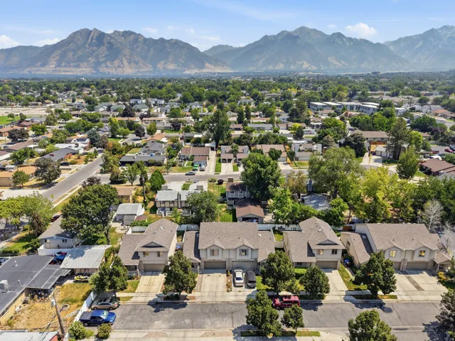 Residential neighborhood featuring mature trees and mountain scenery