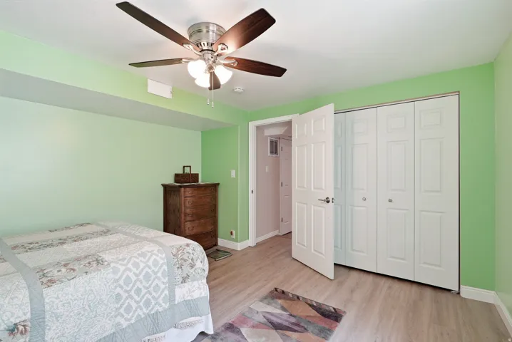 Wood-finish flooring with a ceiling fan light fixture