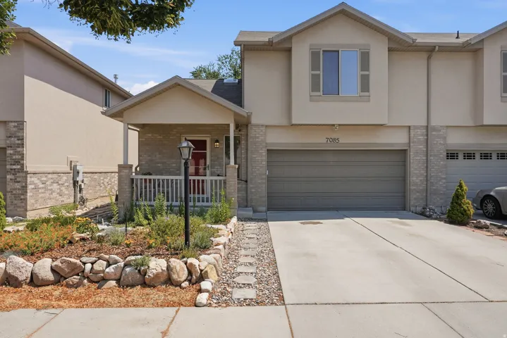 Neutral-toned stucco exterior with brick accents