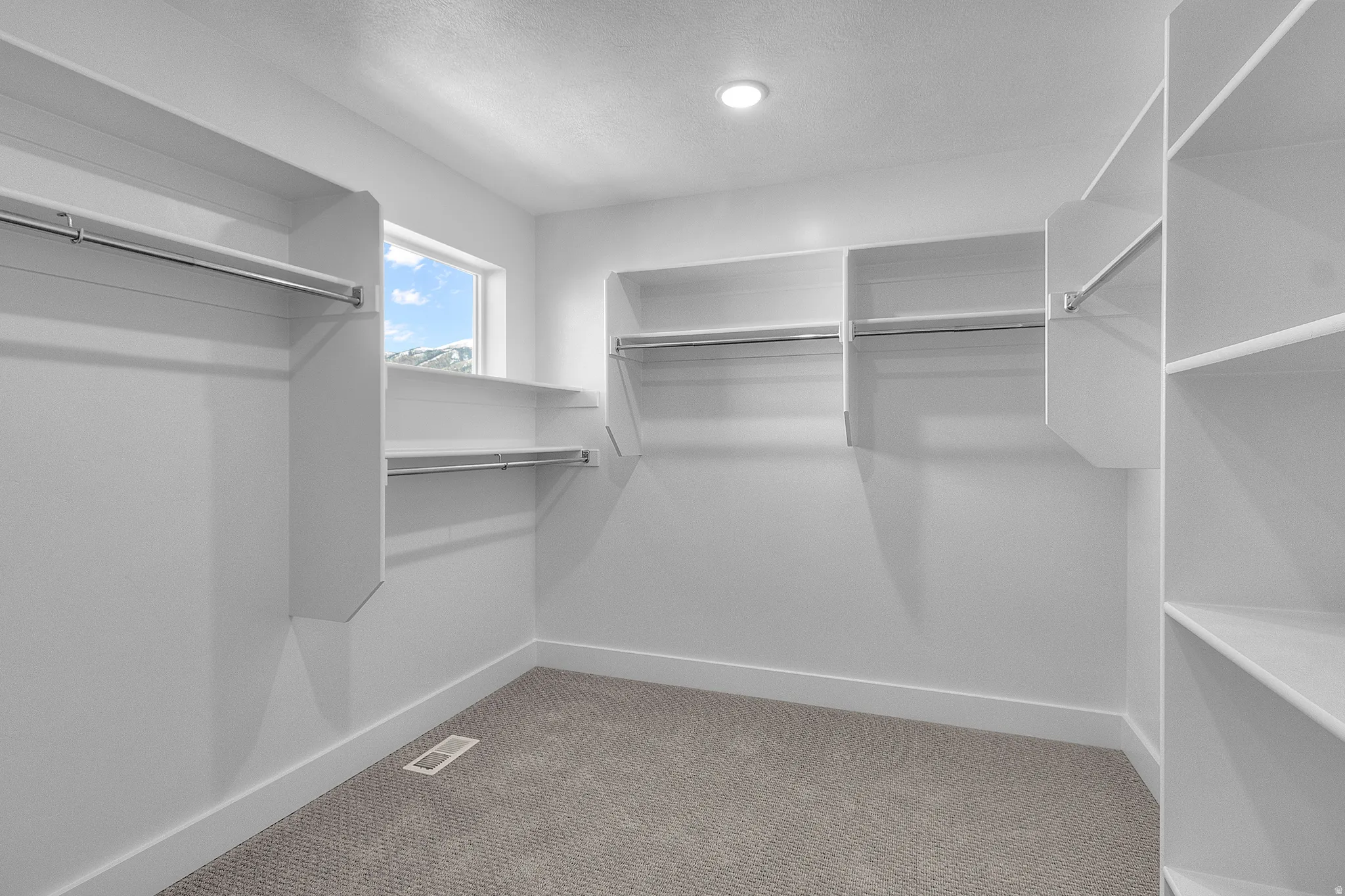 Primary bedroom walk-in closet