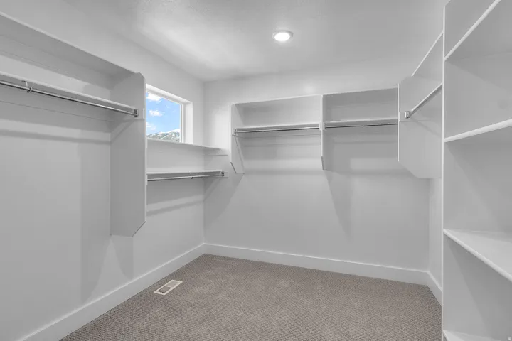 Primary bedroom walk-in closet