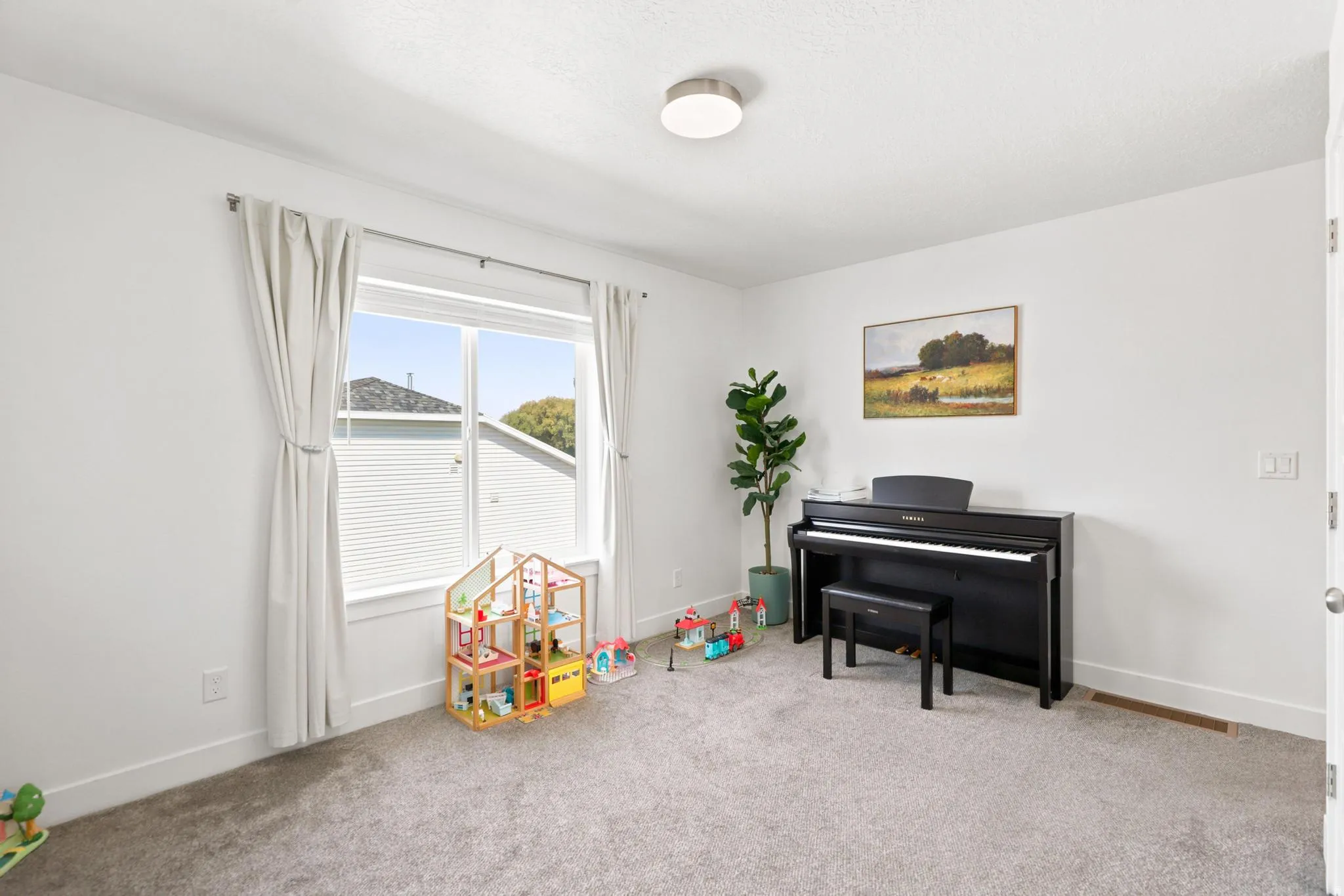 Carpeted flooring with white baseboards and window trim