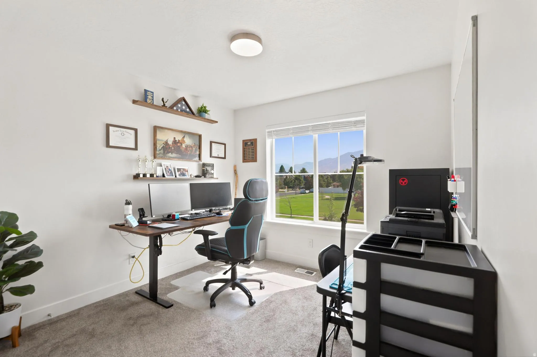 Bright room with a large window, wall-mounted shelving, and recessed ceiling lighting