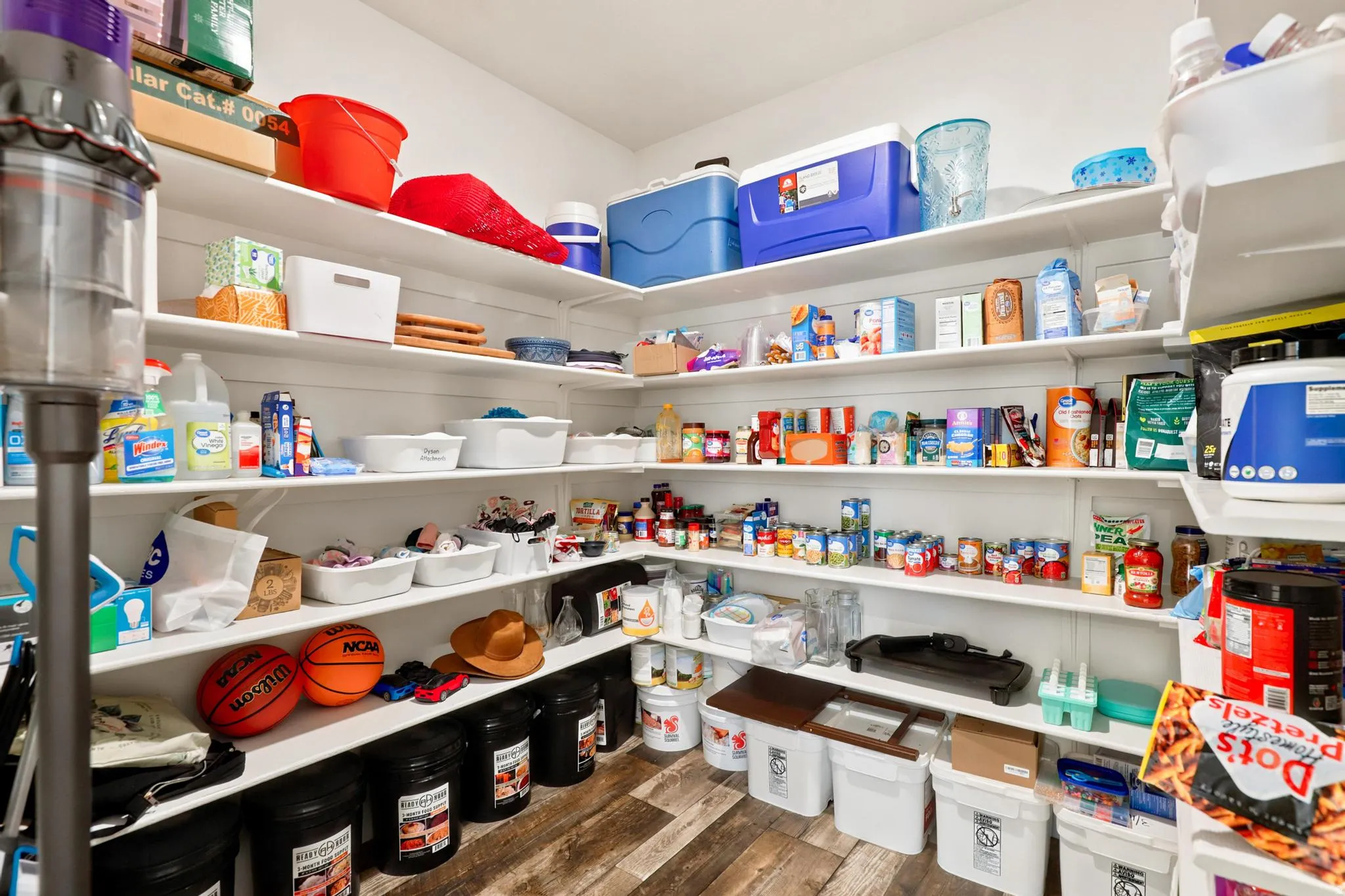 Built-in shelving with L-shaped configuration and wood-finish flooring