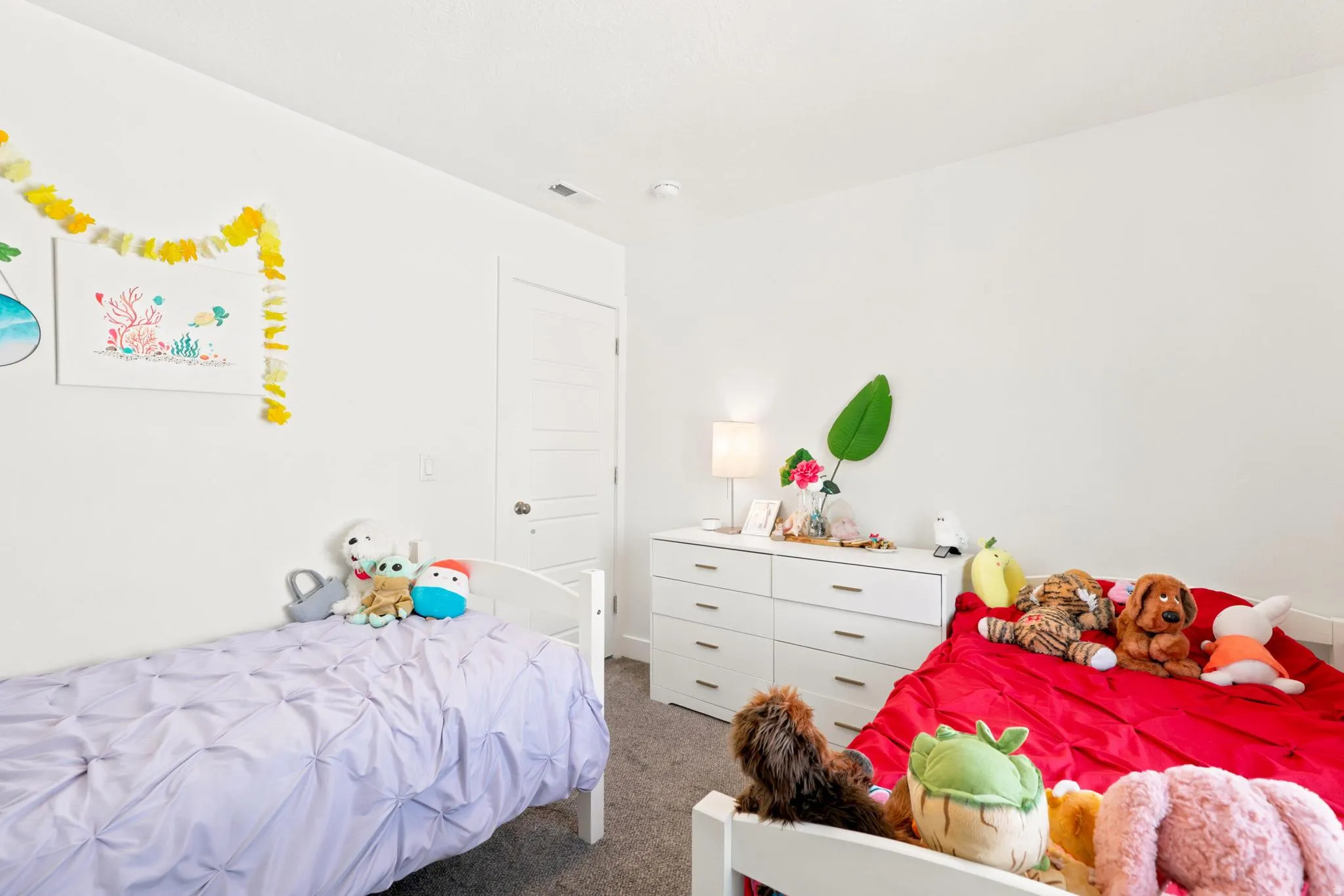 White walls, white doors, and gray carpet flooring
