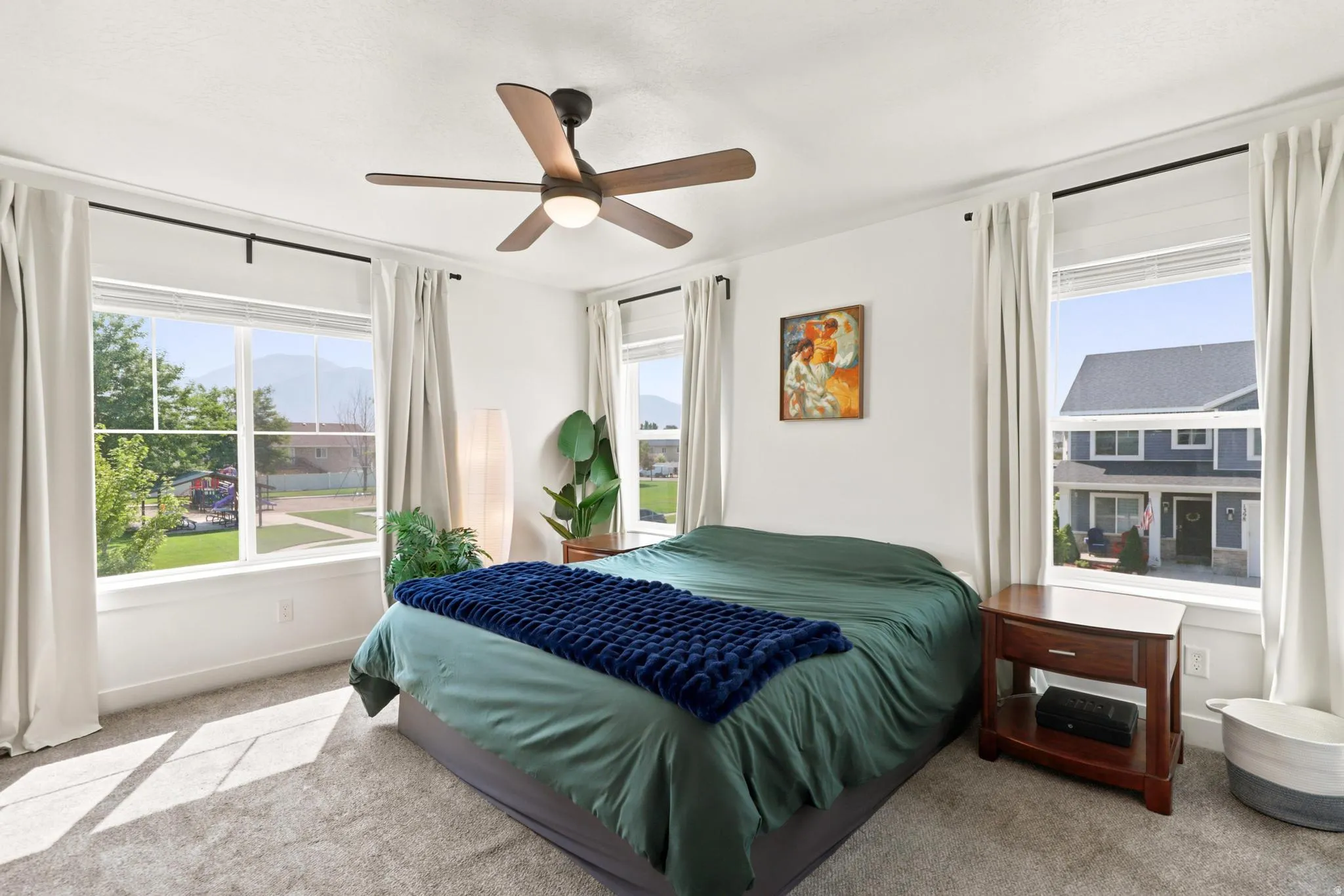 Recessed lighting, ceiling fan with integrated light, multiple windows, plush carpet, and white walls