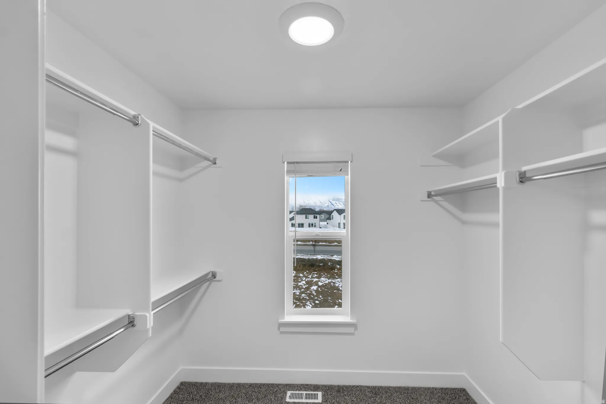 Walk in closet in the primary bedroom