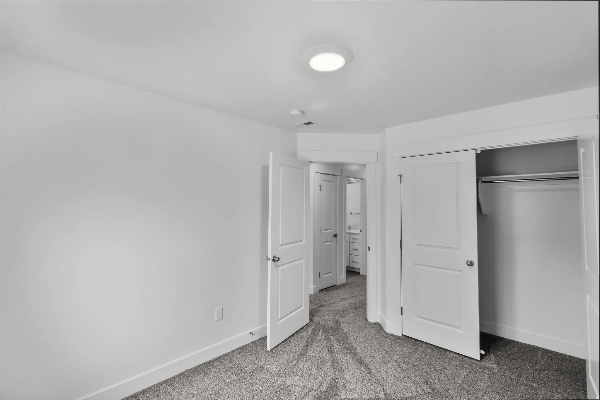 Plush carpeting, recessed ceiling lighting, a built-in closet with sliding doors, and white interior doors