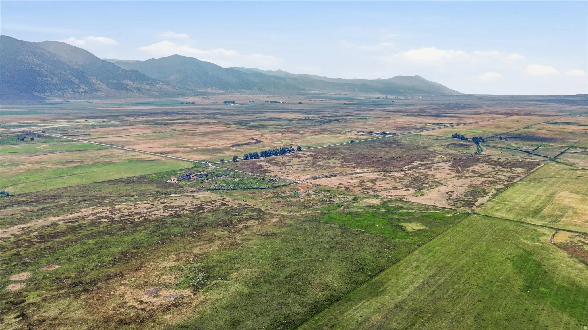 Expansive open landscape with distant mountain ranges and varied terrain