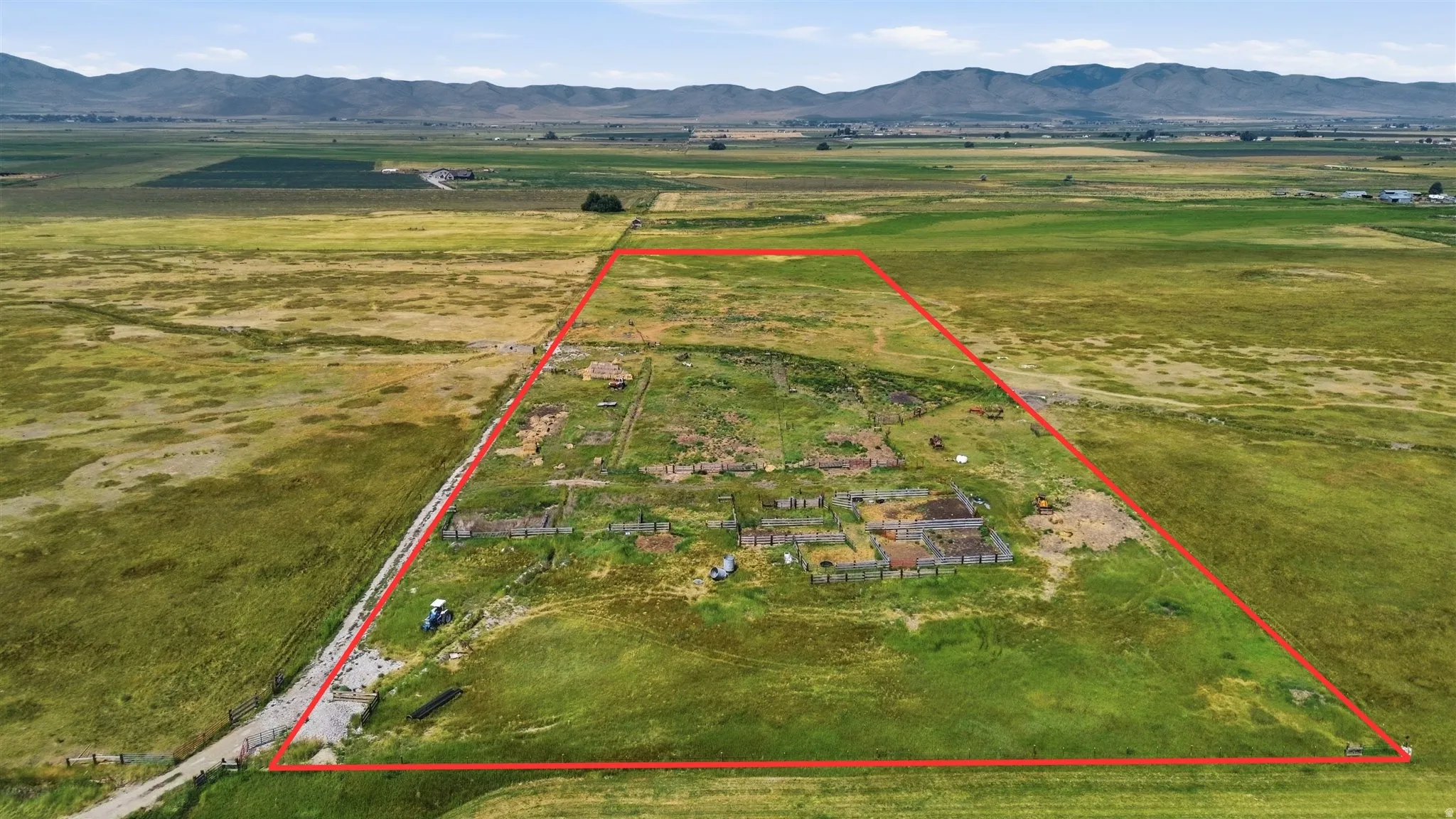 Expansive land parcel with surrounding agricultural fields and distant mountains
