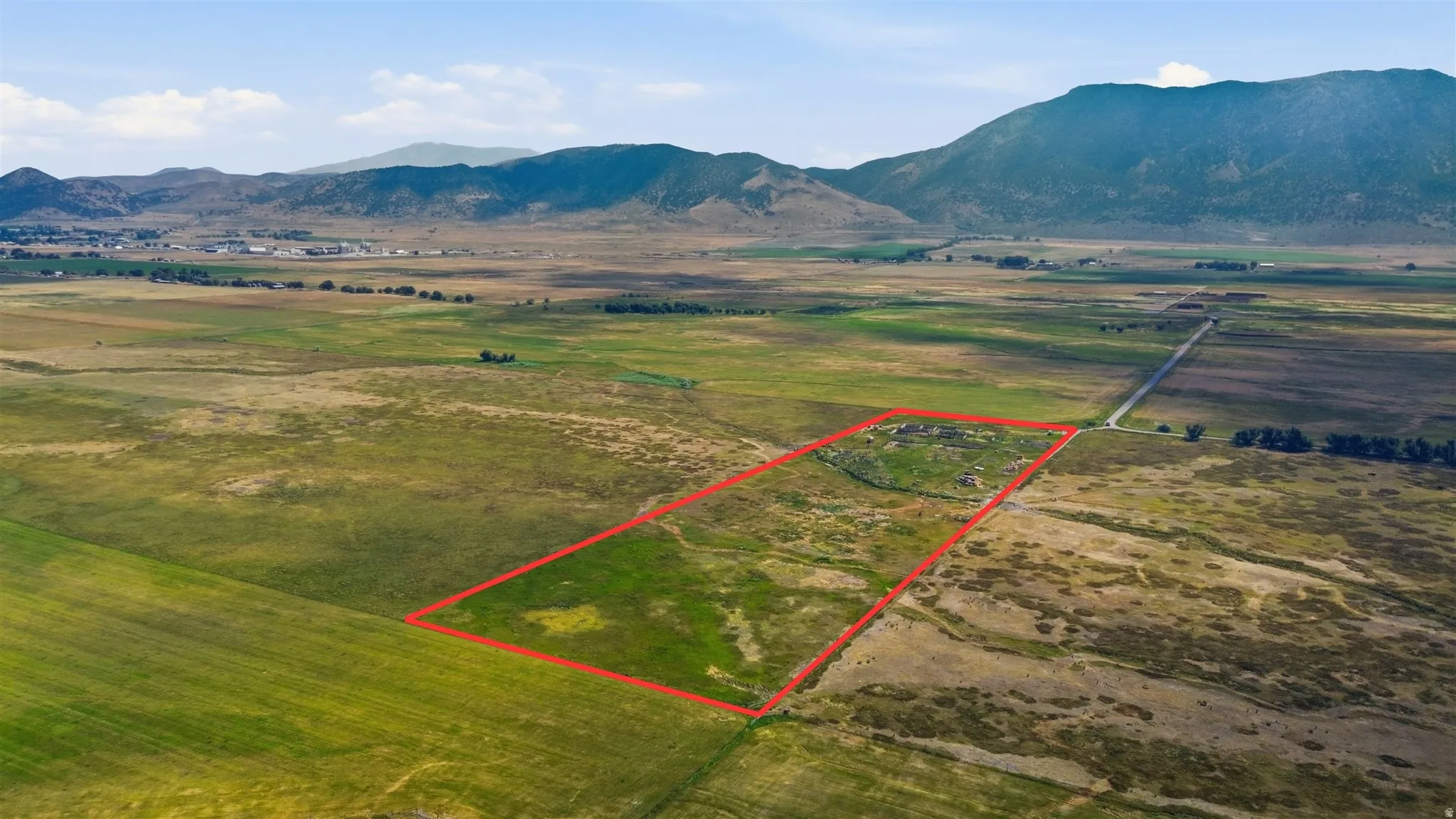 Expansive land parcel featuring open fields and distant mountains