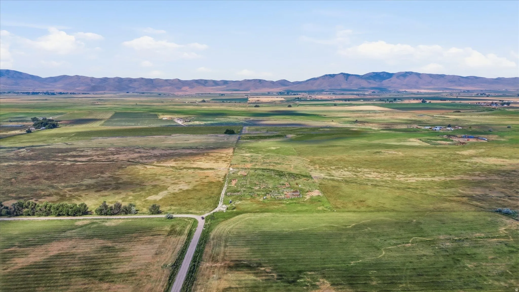 Expansive open land with distant mountains under a clear sky