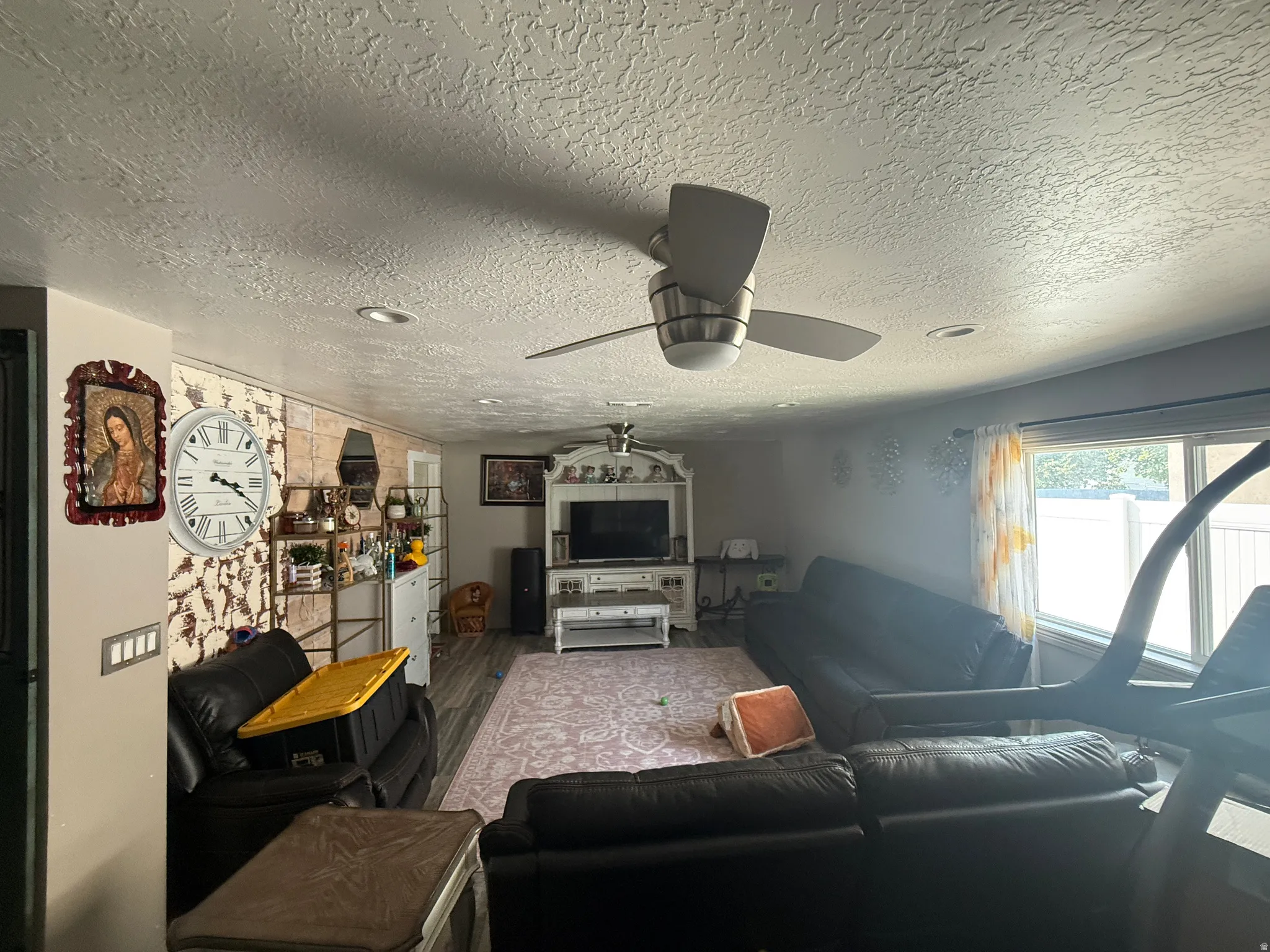 Recessed ceiling lighting, ceiling fan, and wood-finish flooring