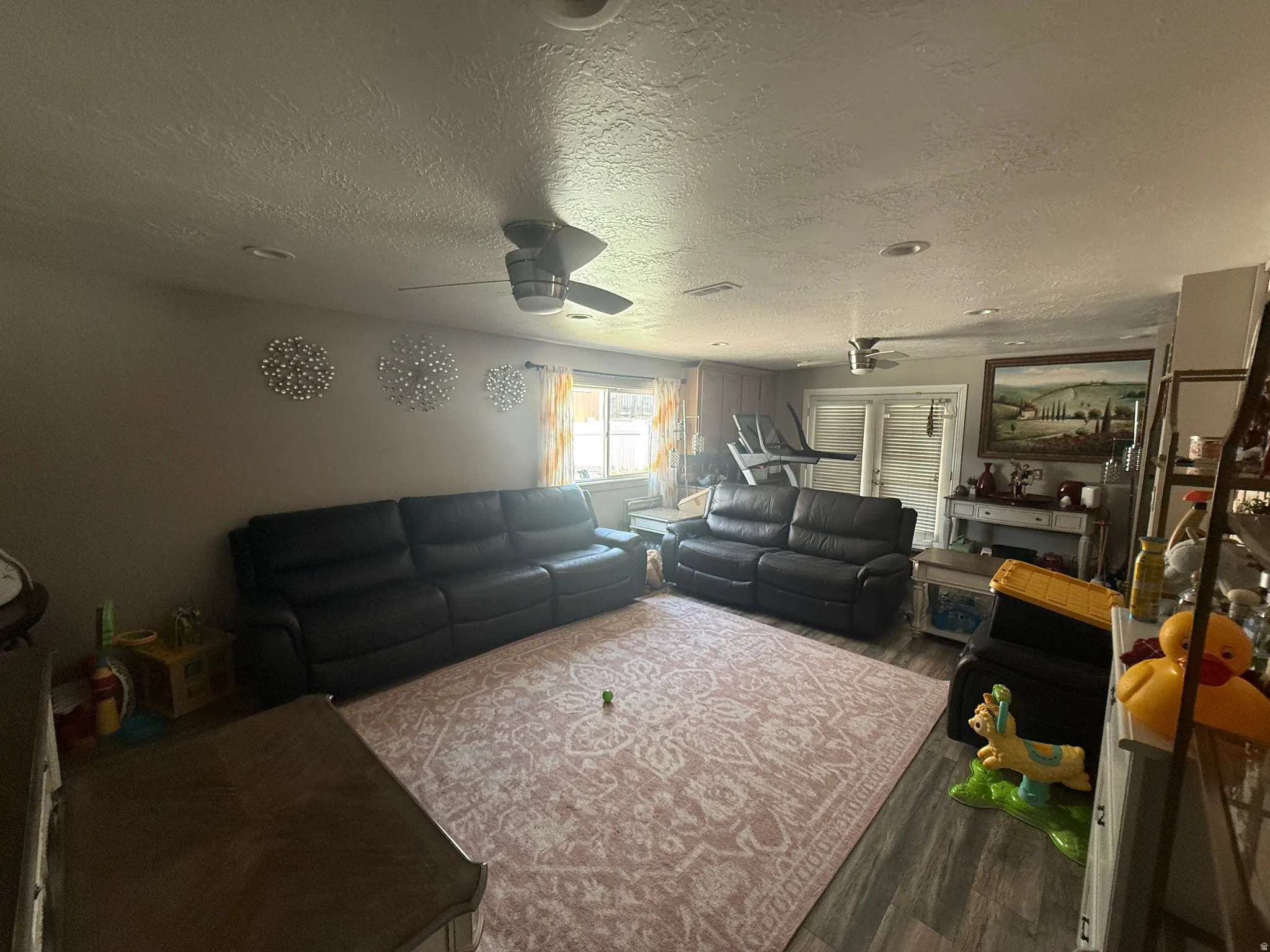Recessed lighting, wood-finish flooring, ceiling fan, and double-door entryway