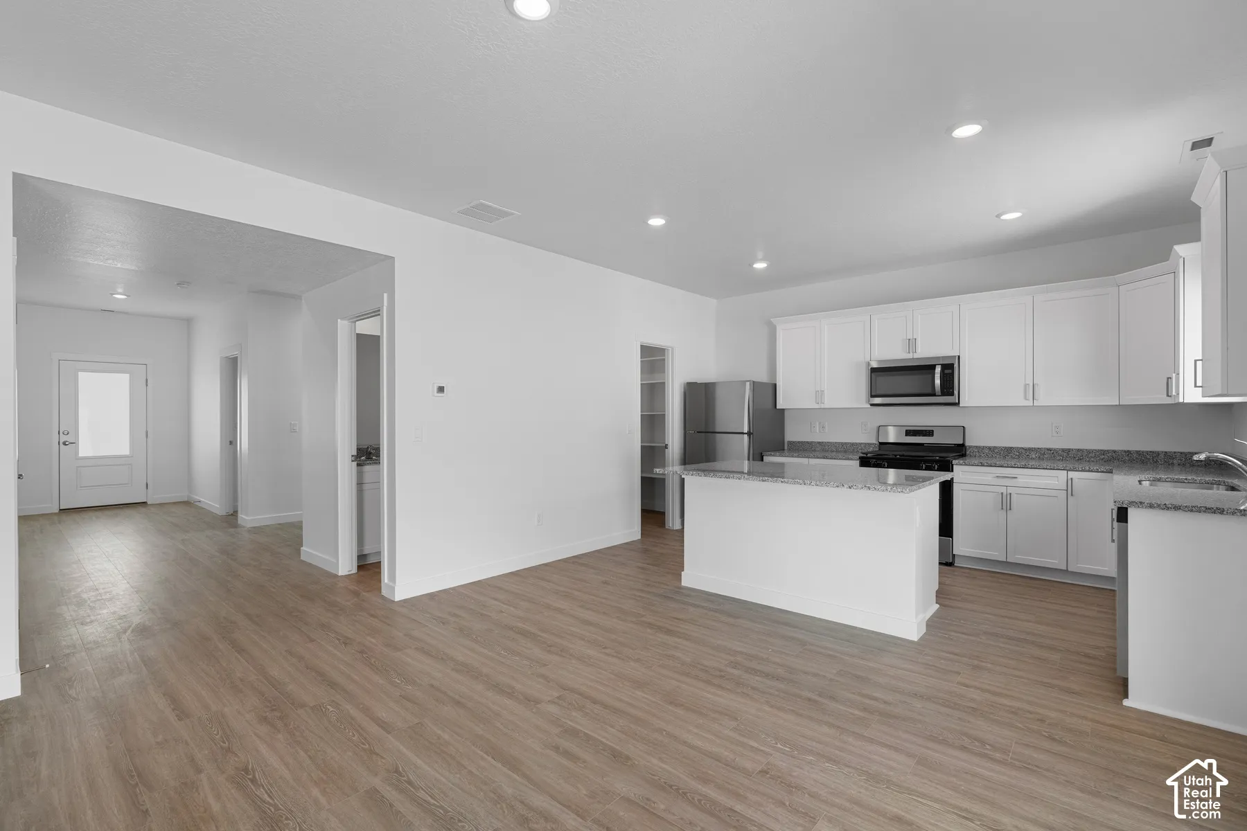 Open-concept living space with wood-finish flooring