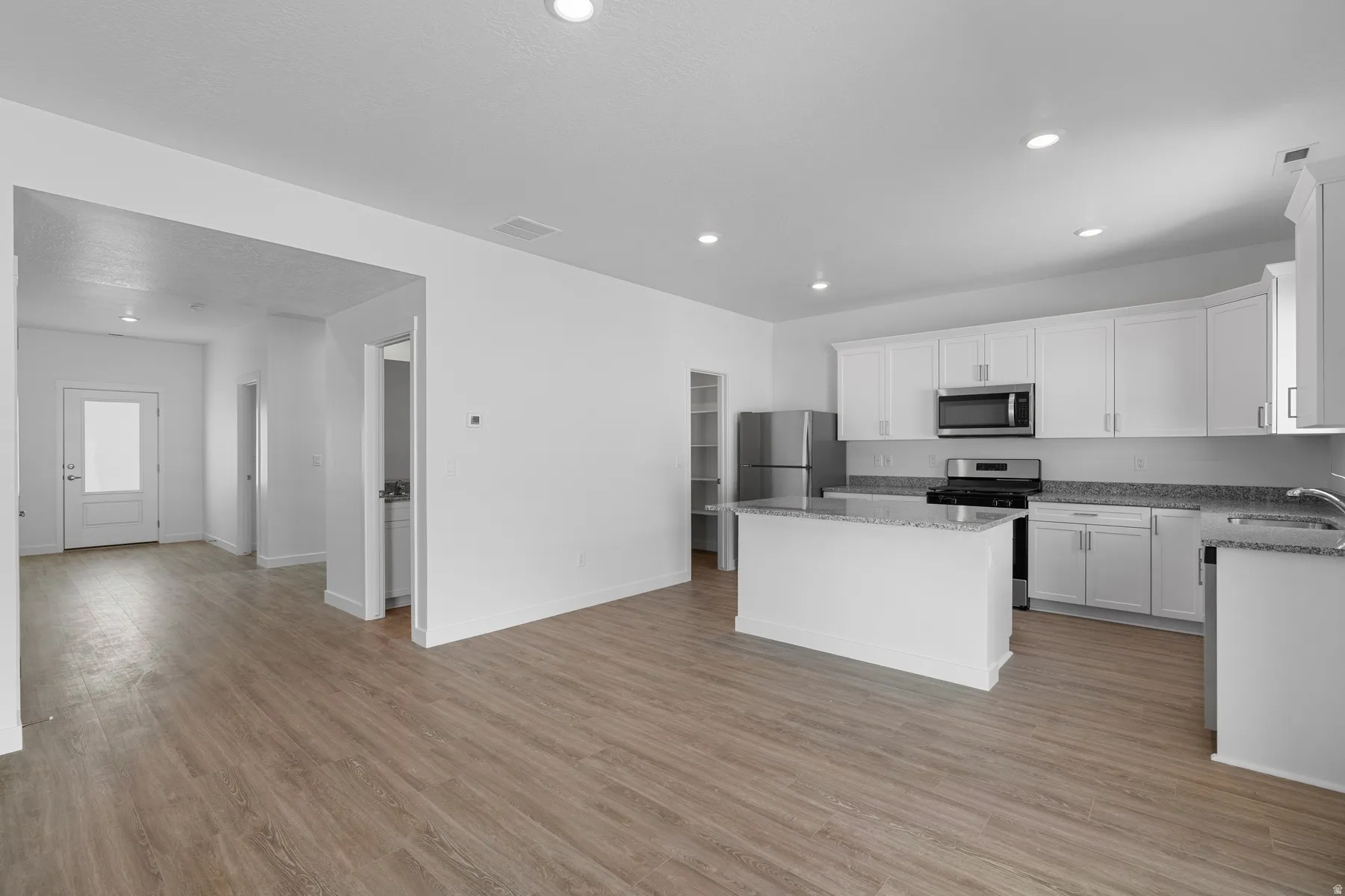 Open-concept living space with wood-finish flooring
