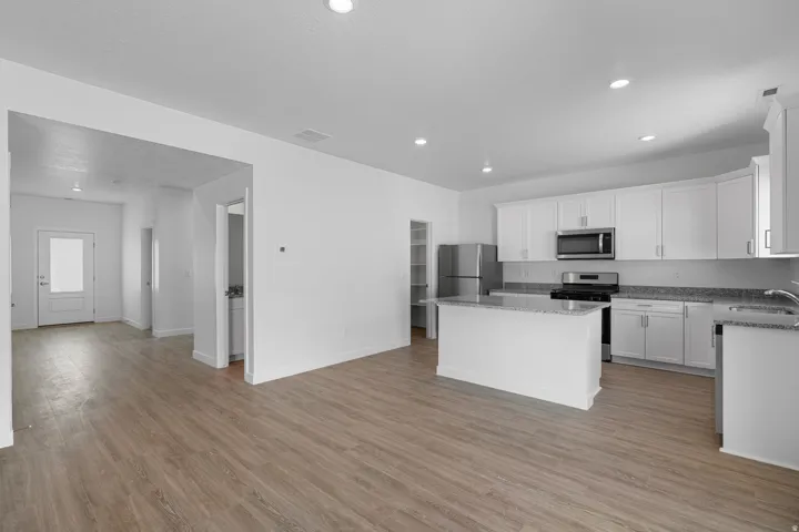 Open-concept living space with wood-finish flooring