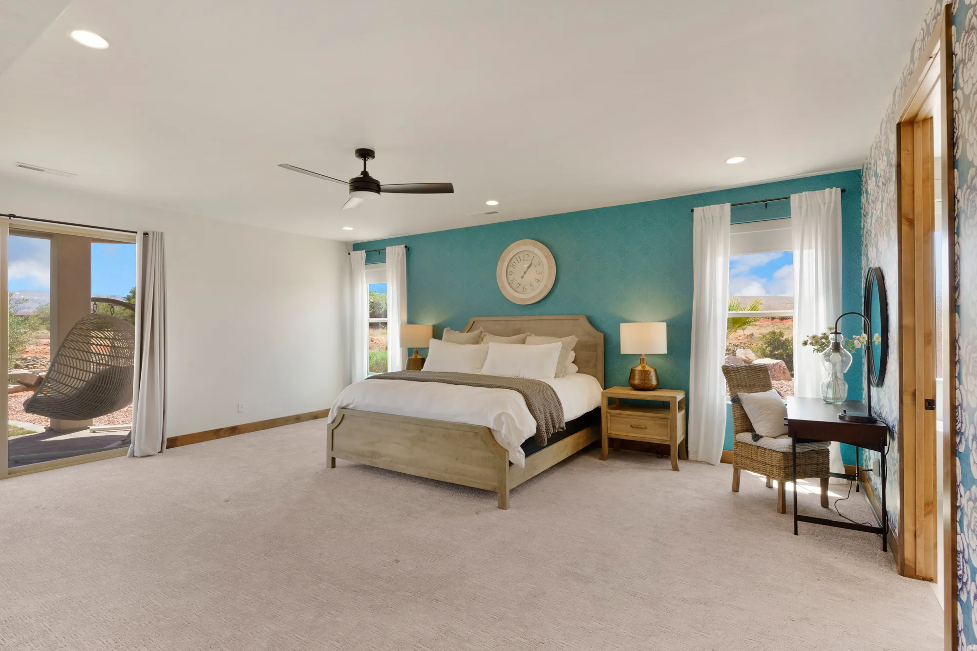 Spacious room with a textured accent wall, recessed lighting, and a ceiling fan