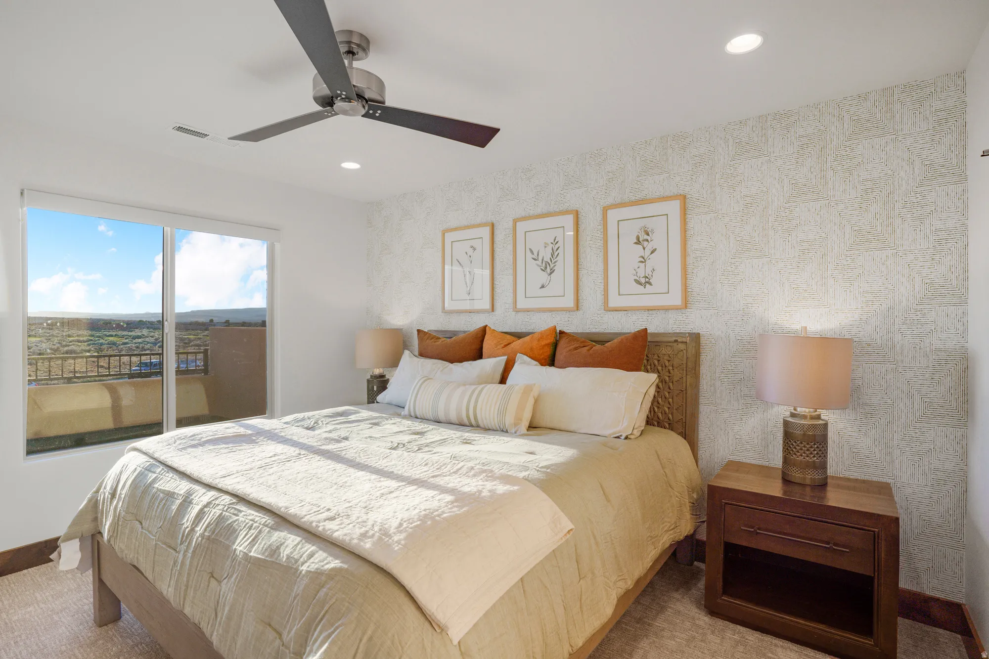 Large sliding glass door, recessed lighting, ceiling fan, accent wall with textured finish, wood-finish flooring
