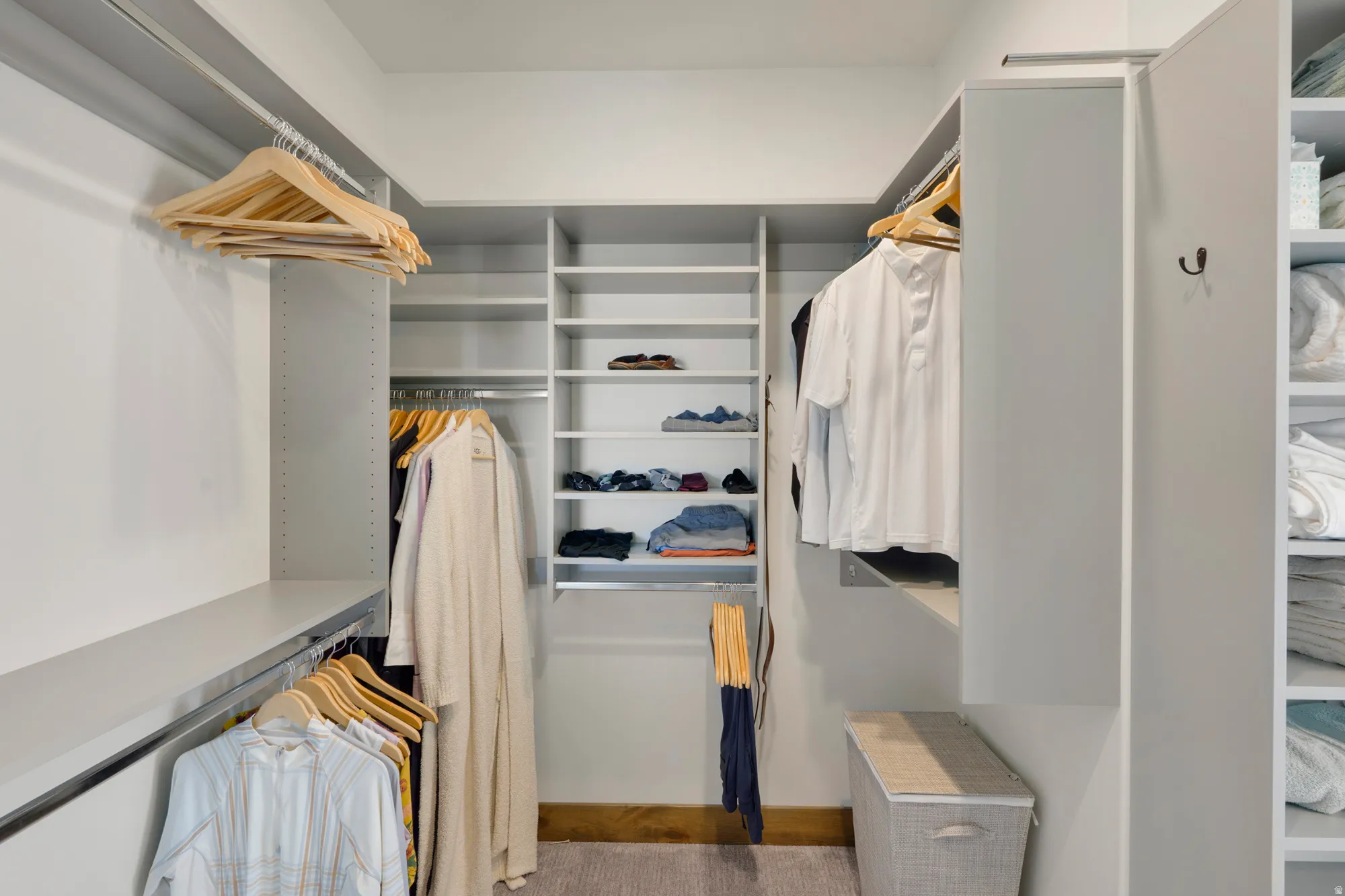 Custom closet system with multiple shelving units, hanging rods, and built-in storage