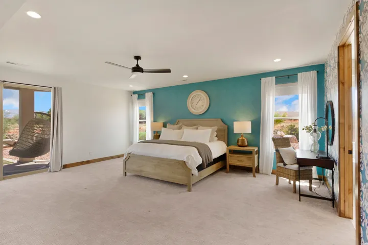 Spacious room with a textured accent wall, recessed lighting, and a ceiling fan