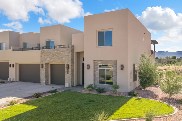 Stucco exterior with stone accents and multiple windows