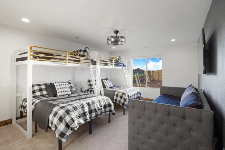 Recessed lighting, ceiling fan, carpeting, window with distant mountain scenery, and an accent wall