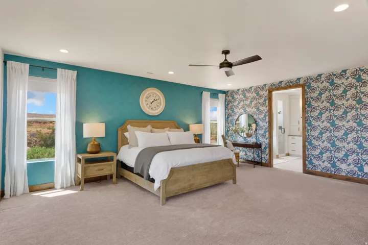 Recessed lighting, ceiling fan, carpeting, two windows, and patterned accent wall