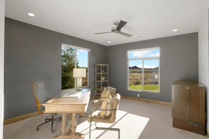 Recessed lighting, ceiling fan, two windows, and carpet flooring