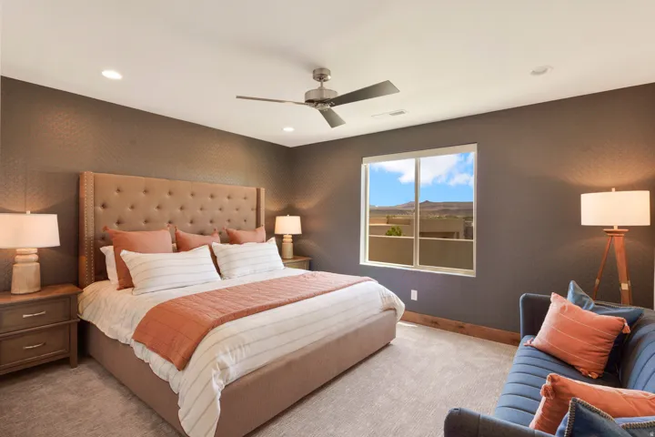Textured accent wall, recessed lighting, ceiling fan, large window, and carpet flooring