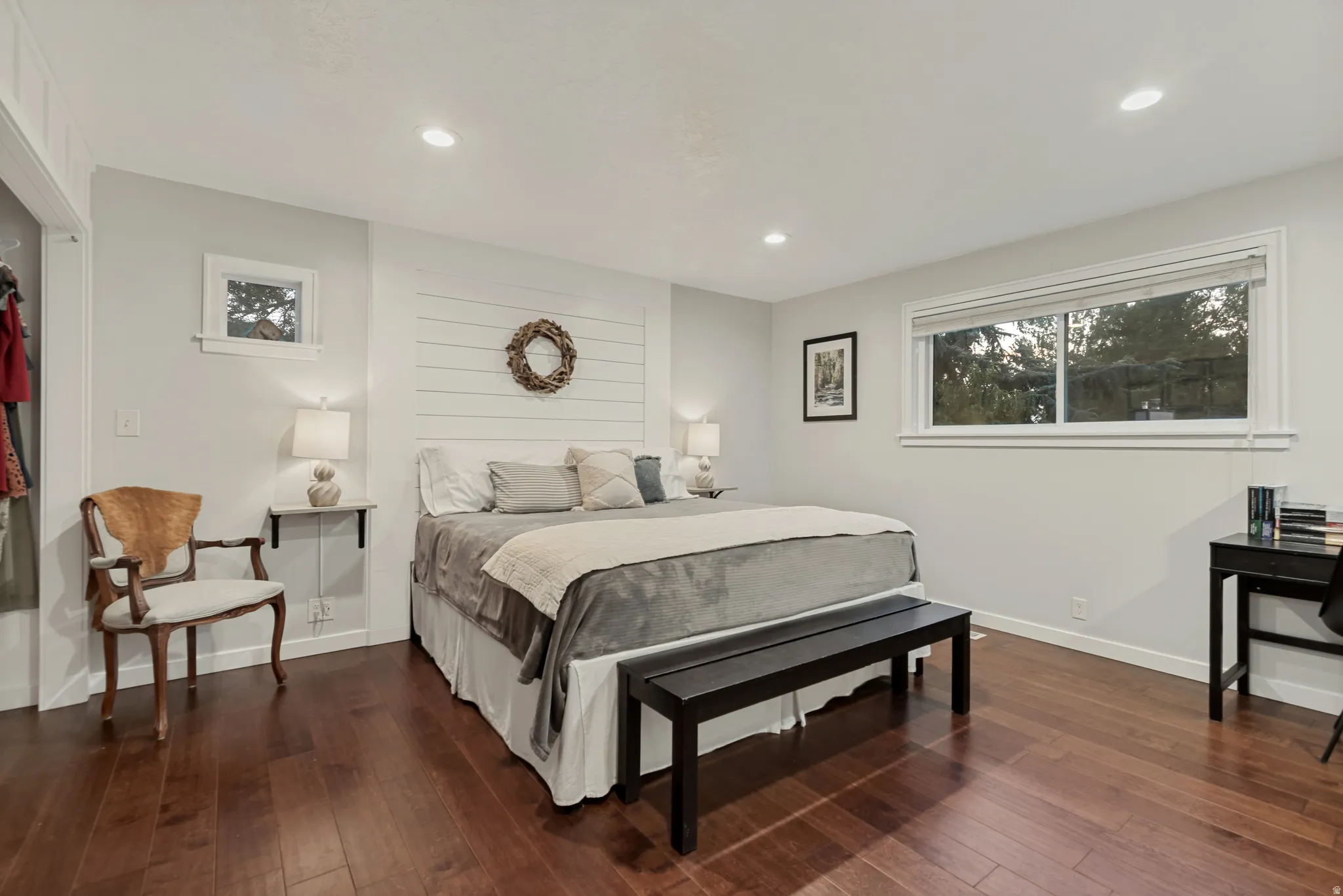 Recessed lighting, wood-finish flooring, white shiplap accent wall, white trim, and a large window