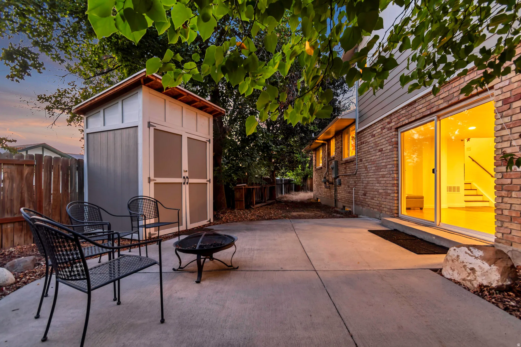 Expansive concrete patio with brick exterior and siding accents