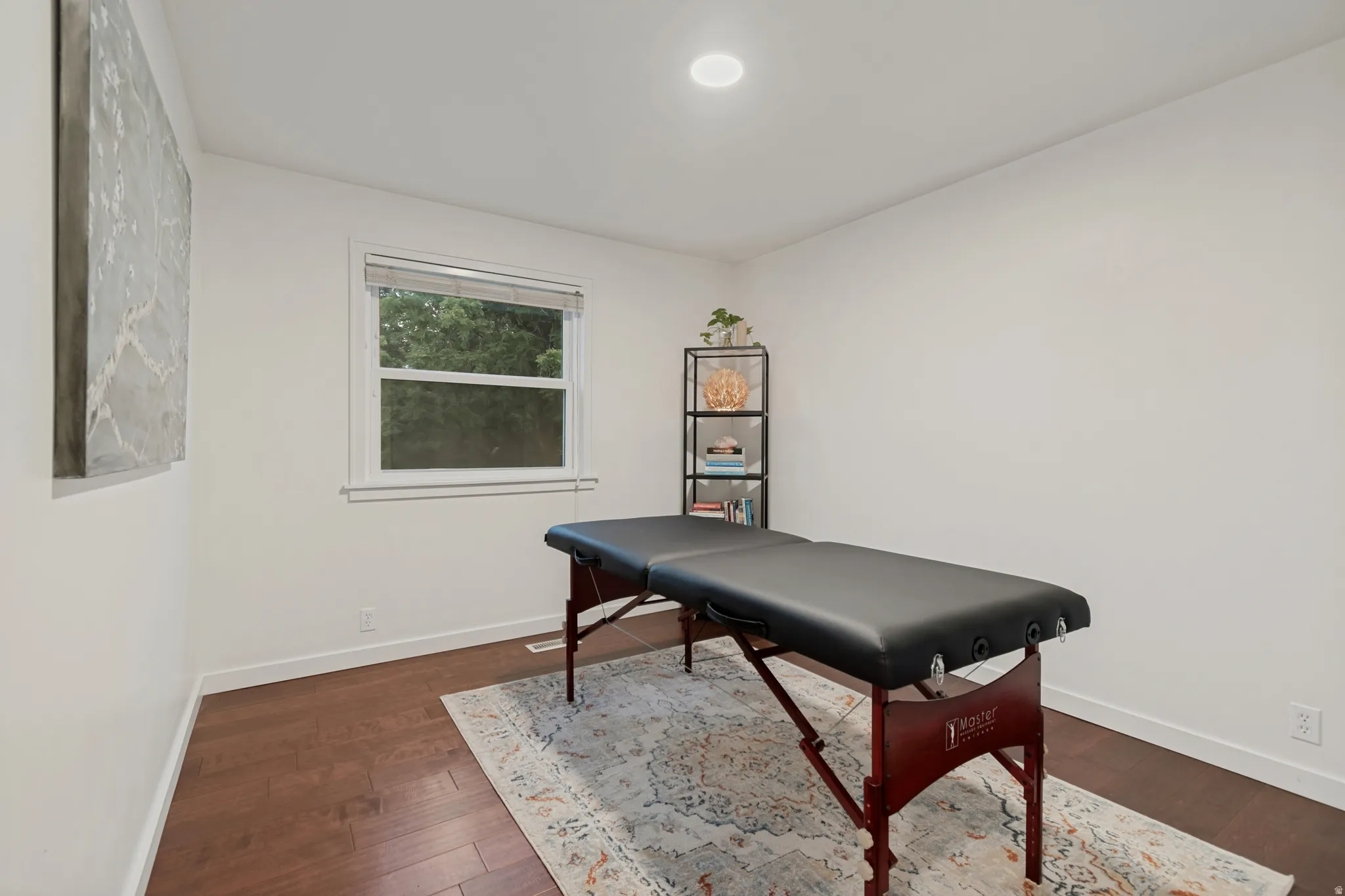 Wood-finish flooring, recessed ceiling lighting, and a window with blinds