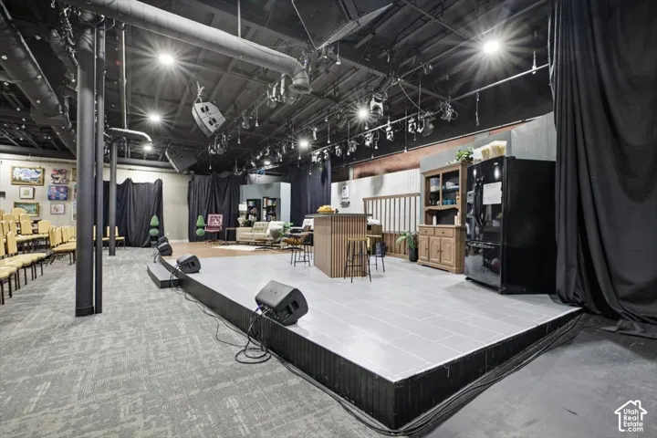 Raised stage with light-toned tiled surface