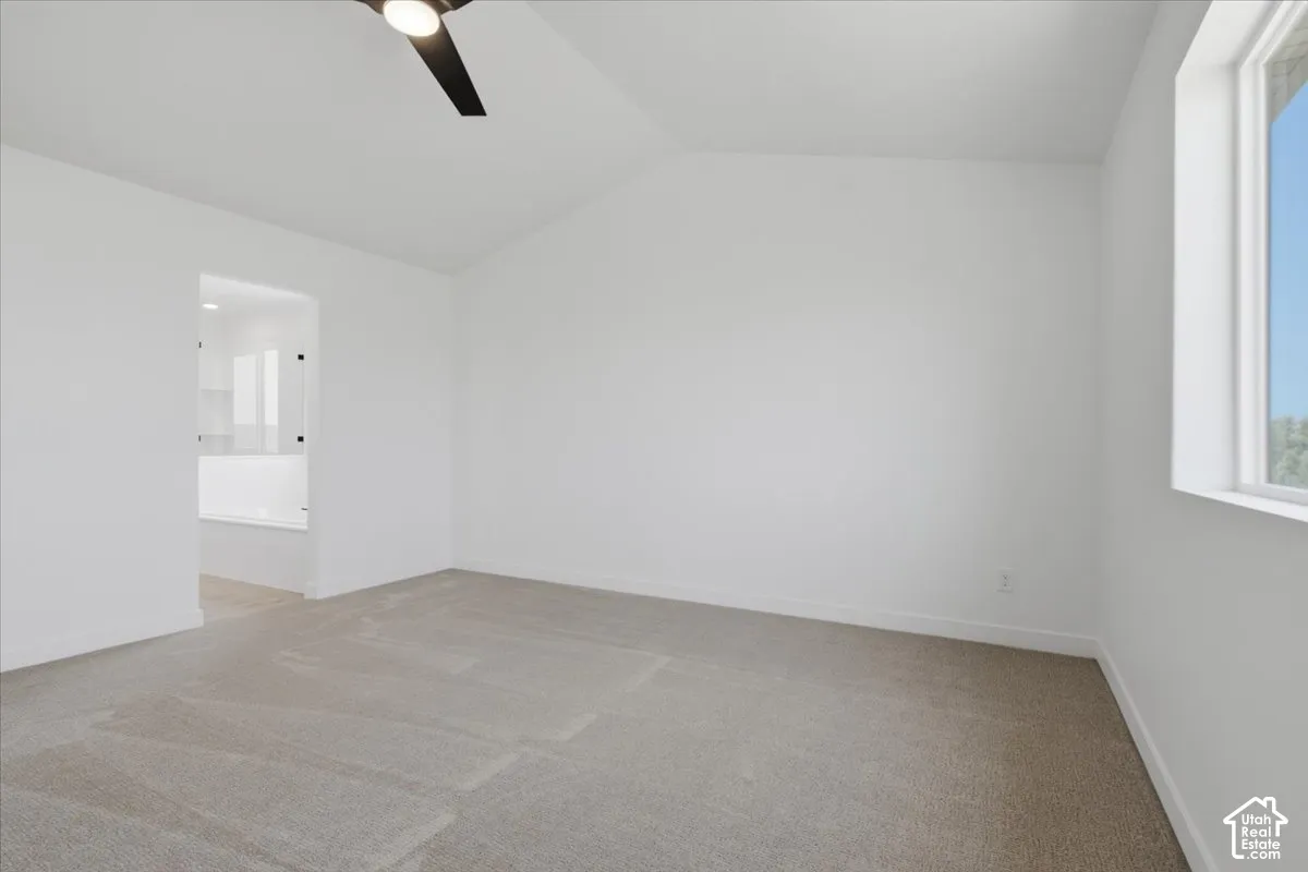 Primary Bedroom with vault and ceiling fan.