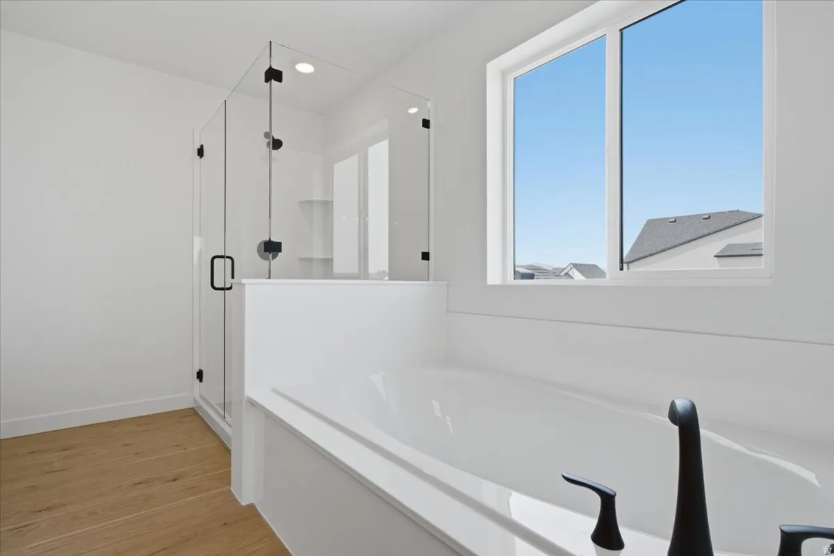 Large shower with a full euro shower enclosure.  Relax in the oversized 6' Tub.