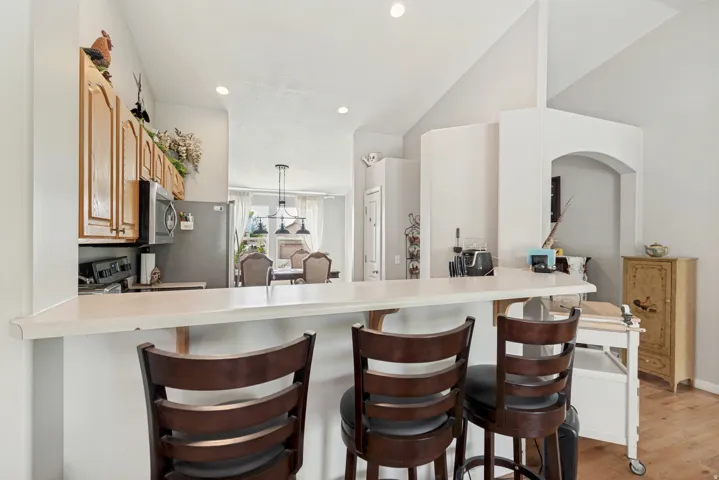 Kitchen featuring wood cabinetry, stainless steel appliances, and a breakfast bar