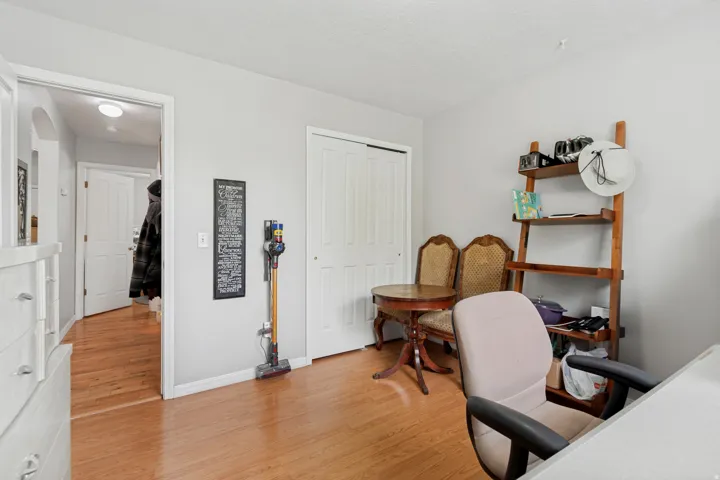 Hardwood flooring, light gray wall paint, and white trim
