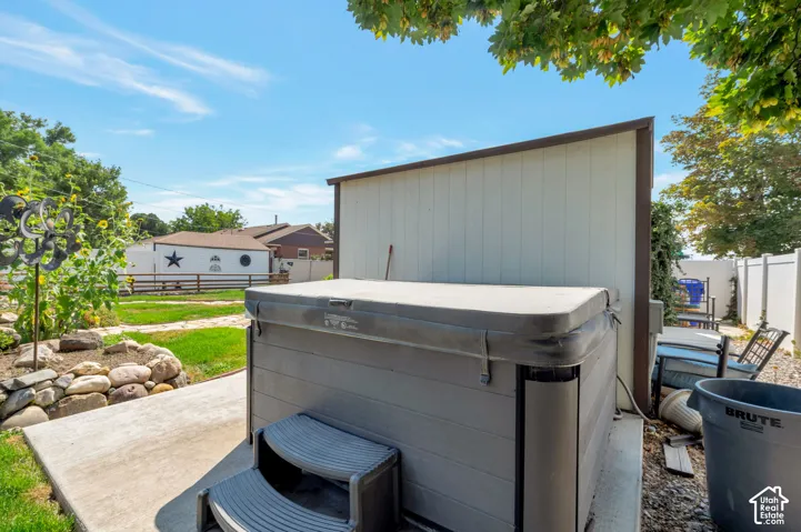 Outdoor spa with steps on a concrete pad