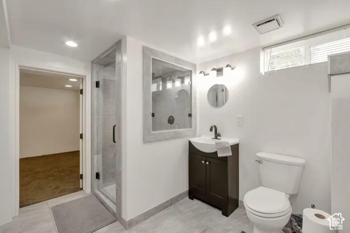 This brand new bathroom boasts a walk-in shower with clear glass enclosure and tile surround