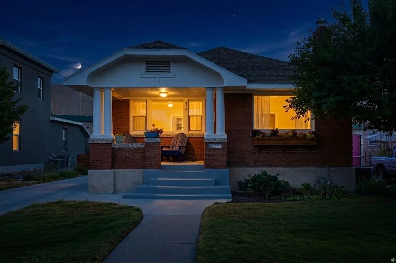 Brick exterior with a covered front porch featuring white columns