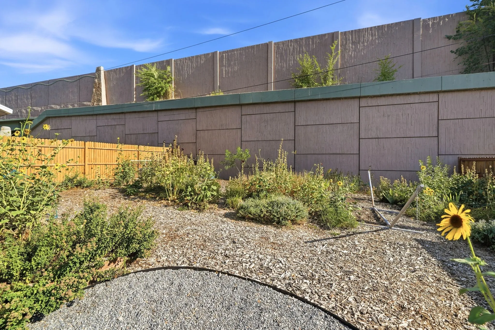 Terraced landscaping featuring a gravel path and mature plantings